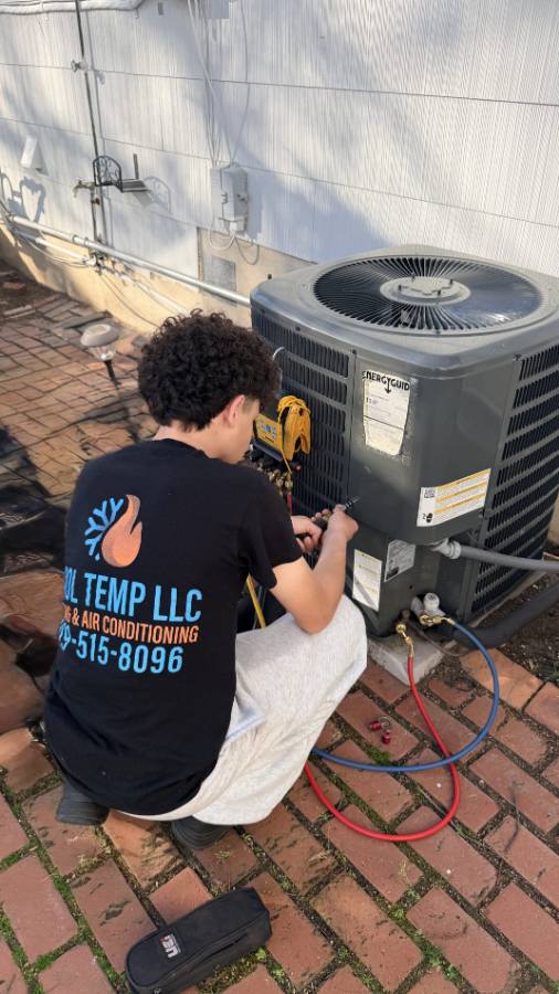 Cool Temp tech servicing an AC condenser in Atlantic County