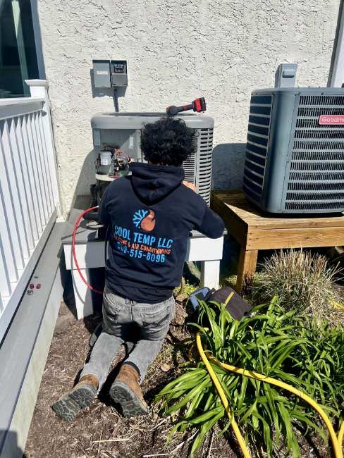 Cool Temp technician servicing outdoor cooling equipment