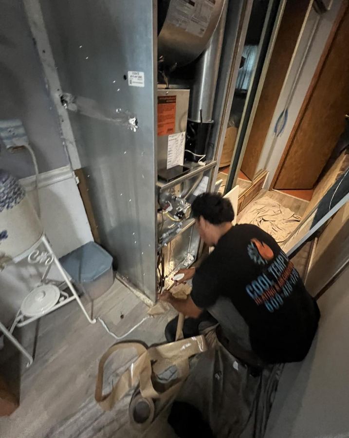 Cool Temp tech servicing a closet furnace in Atlantic County NJ