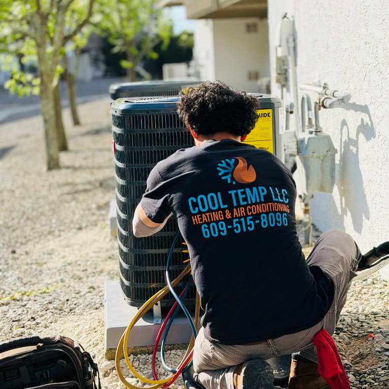 Cool Temp technician charging refrigerant at a condenser in Pleasantville NJ