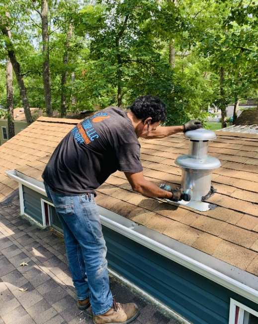 Cool Temp tech installing a roof vent cap